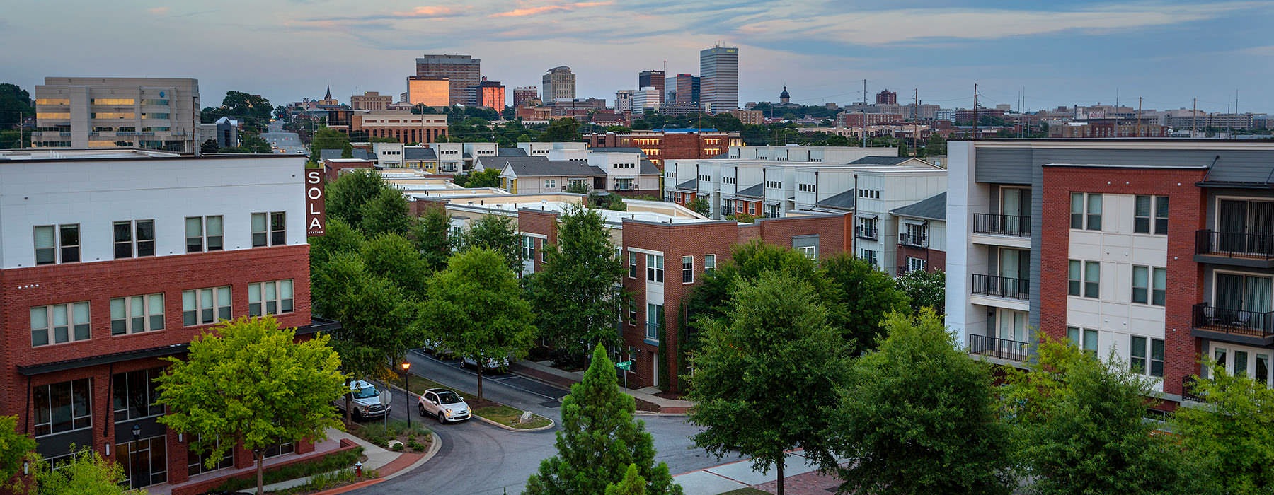 neighborhood with city skyline in the background